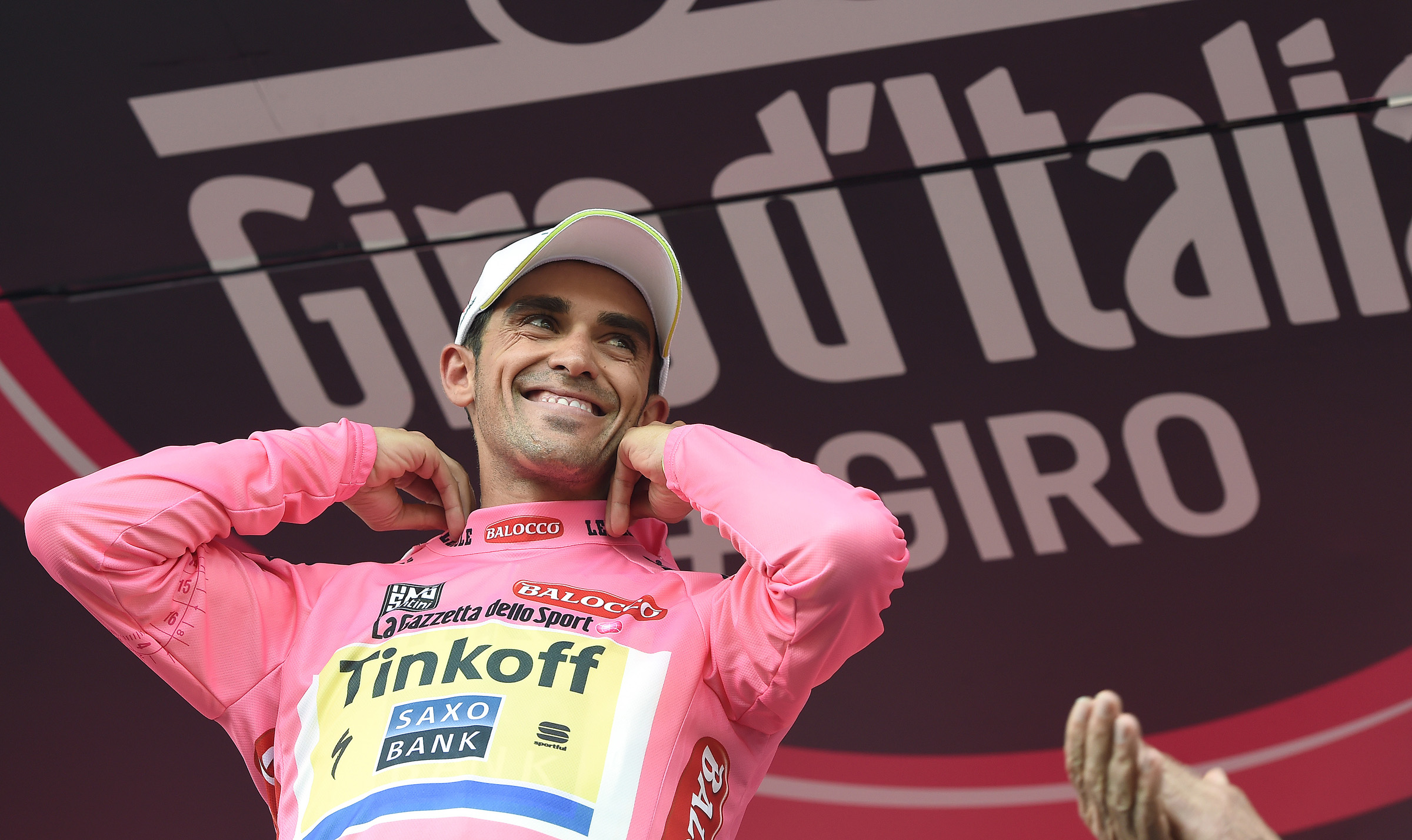 The new overall leader, Spanish rider Alberto Contador of Tinkoff-Saxo team, smiles a s he wears the pink jerseyon the podium of the fifth stage of the 98th Giro d'Italia cycling tour over 152km from La Spezia to Abetone, Italy, 13 May 2015. ANSA/DANIEL DAL ZENNARO